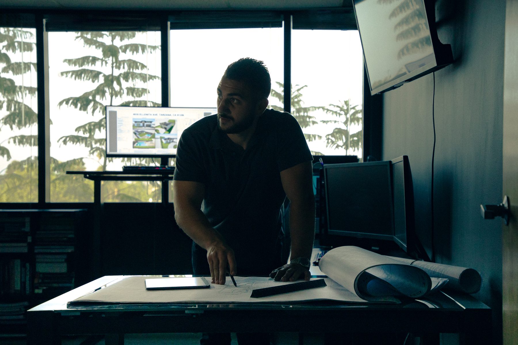 Souren Grigoryan reviewing structural plans at SG Design Studio